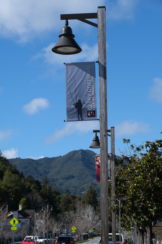 Winner banner with name of artist over photo hangs over Miller Avenue in Mill Valley, California